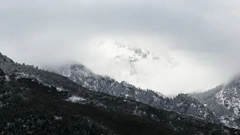 Descending aerial view of Utah's cold rugged mountains during Spring time with Stock Footage 341484758