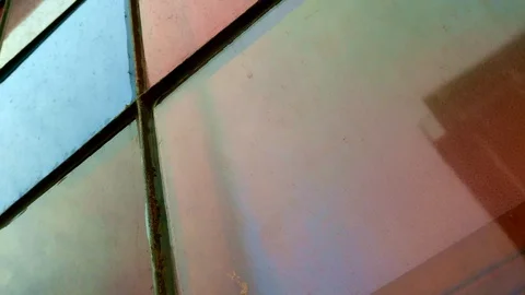 Descending along colourful windows with reflections of other buildings Stock Footage 109095379