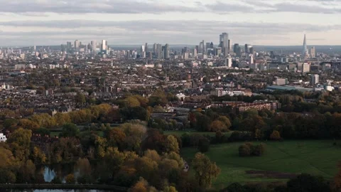 Descending circling left over Hampstead Heath with reflective swimming ponds Stock Footage 295839333