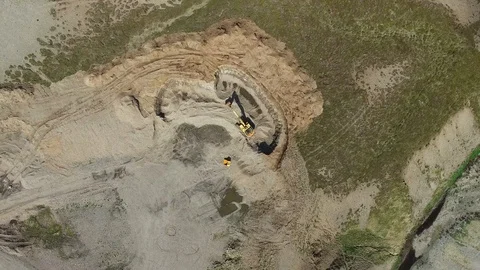 Descending down to an excavator in an open pit in Iceland (4k drone footage) Stock Footage 88771960
