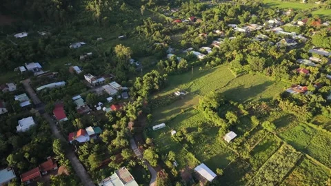 Descending drone flight over rural village at golden hour in Vietnam Stock Footage 337948372