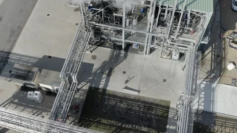 Descending drone over industrial unit with steam, France Stock Footage 310334181