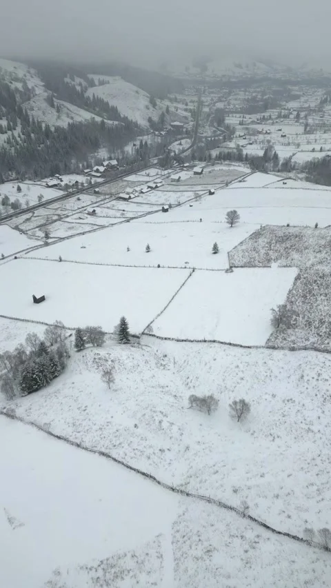 Descending Drone View of Snowy Fields Stock Footage 296738192