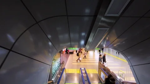 Descending on the escalator at Tokio railway station. View of platform. Japan Stock Footage