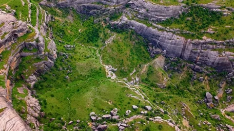 Descending Flight Through a Dramatic Valley of Towering Green Rock Formations Stock Footage 341240014