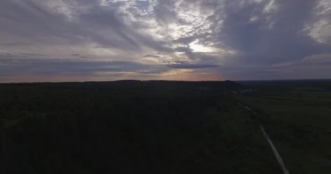 Descending fly over trees road fields evening 스톡 동영상 108744971