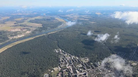 Descending from a great height between the clouds, aerial view of a city Stock-Footage 254084184