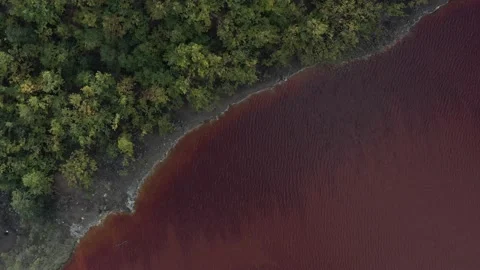 Descending on red mining site waters 4K aerial footage Video stock 142167602