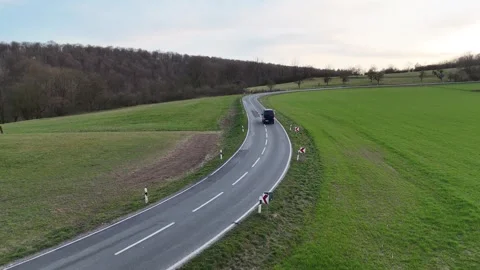 Descending roadside view with van and upward gimbal tilt Stock Footage 331211698
