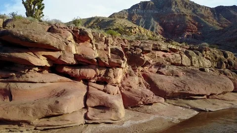 Descending into sculpted river canyon with dramatic red rock in late afternoon s Stock-Footage 83056535
