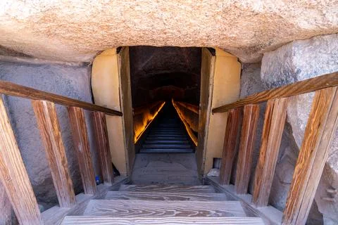 Descending steps exploring ancient egyptian pyramid passage Фото