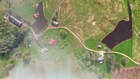 Descending top-down aerial over rural Latvian farmland Stock-Footage 337588815
