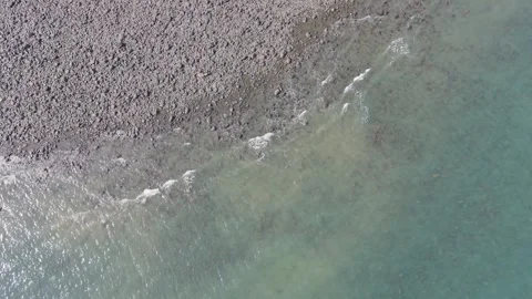 Descending Top Down View of Small Waves Rolling in to Lynmouth Beach. Stock Footage 342269970