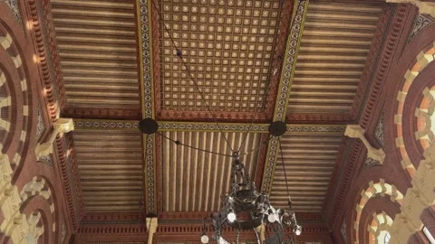 Descending view from the ornate ceiling of Aranjuez railway station hall Stock Footage 340566844