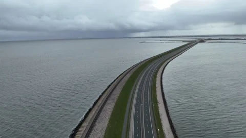 Descending view over dam road and waterside bike path Stock Footage 331829023