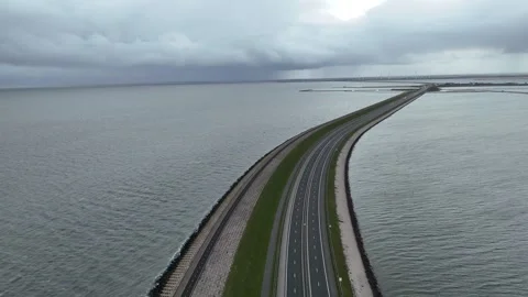 Descending view over dam road and waterside bike path Stock Footage 333436879