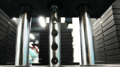 The descent and ascent of the load on the machine at the gym Stock Footage 113175867