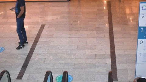 Descent between floors on an escolator in a large modern shopping center Stock Footage 141866943