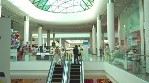 Descent between floors on an escolator in large modern shopping center Stock Footage 141869312