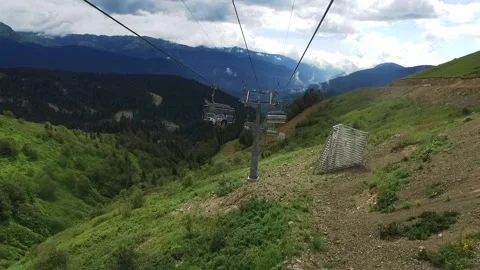 Descent on a cable car. View from the ski lift in the mountains to the green Stock Footage 141303485