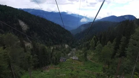 Descent on a cable car. View from the ski lift in the mountains to the green Stock Footage 142722748