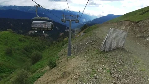 Descent on a cable car. View from the ski lift in the mountains to the green Stock Footage 142981881
