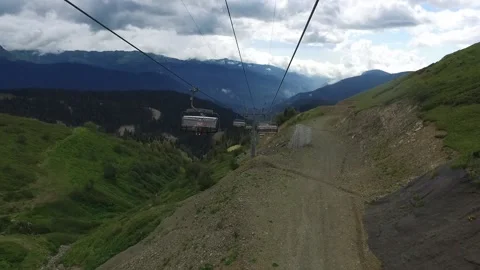 Descent on a cable car. View from the ski lift in the mountains to the green Stock Footage 158698986