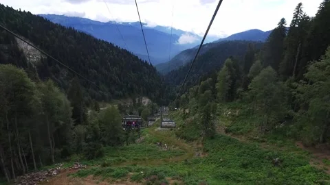 Descent on a cable car. View from the ski lift in the mountains to the green Stock Footage 160538864