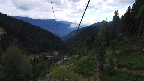 Descent on a cable car. View from the ski lift in the mountains to the green Stock Footage 161927494