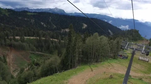 Descent on a cable car. View from the ski lift in the mountains to the green Stock Footage 162392668