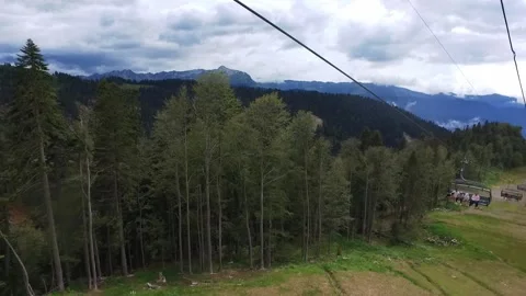 Descent on a cable car. View from the ski lift in the mountains to the green Stock Footage 162913021