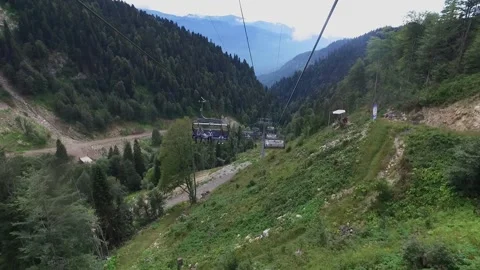 Descent on a cable car. View from the ski lift in the mountains to the green Stock Footage 164885811