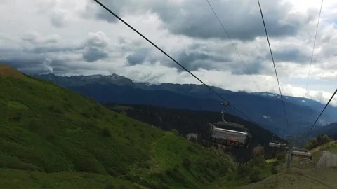 Descent on a cable car. View from the ski lift in the mountains to the green Stock-Footage 165461390