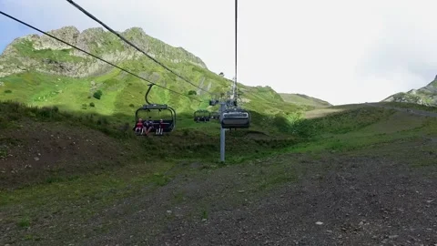 Descent on a cable car. View from the ski lift in the mountains to the green Stock Footage 169435025