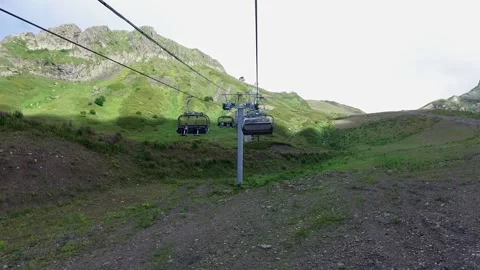 Descent on a cable car. View from the ski lift in the mountains to the green Stock Footage 170938989