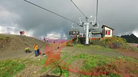 Descent on a cable car. View from the ski lift in the mountains to the green Stock Footage 172343986