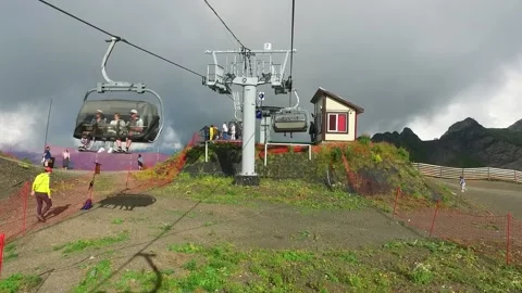 Descent on a cable car. View from the ski lift in the mountains to the green Stock Footage 188259340