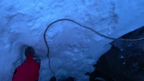 Descent into a deep ice cave. The climber descends Video stock 171180392