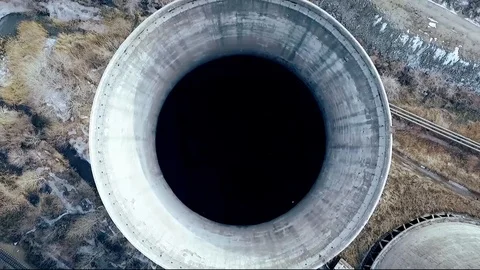 Descent into the huge pipe-cooling tower of a coal power plant Stock-Footage 98274027