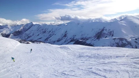 Descent from the mountain peak together with two snowboarders, a very beautiful  Stock Footage 94652060