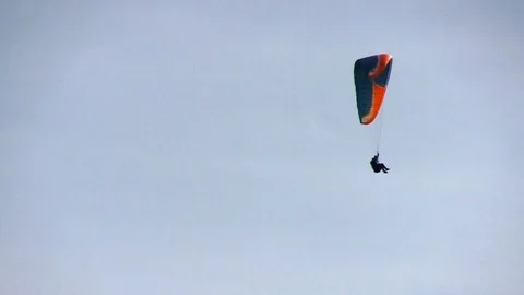 Descent of a paraglider in the sky Stock Footage 104553196