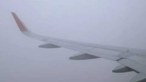 The descent of the plane from the dark clouds from the thickest darkness into Stock Footage 166314307