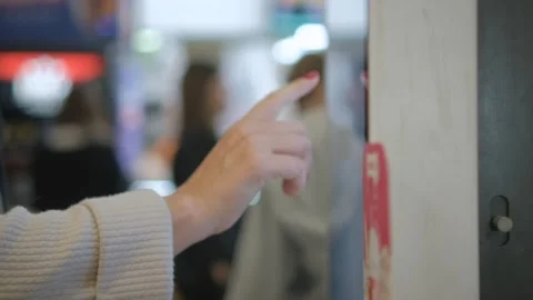 Describing the experience of engaging with a touchscreen kiosk in a lively Stock Footage 277638874