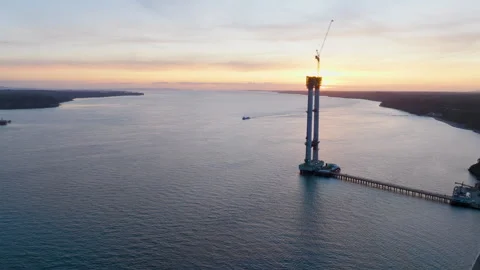 DESCRIPTION Drone footage orbiting Chacao Bridge tower at sunset. The massive Stock Footage 338158934