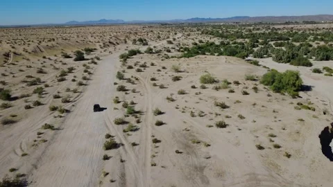 Desert Aerial Fly Over Off Roading Vehicle in Sandy Backcountry Trail Stock Footage 323774096