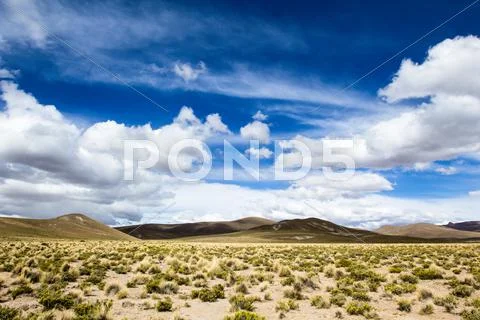 Desert and mountain over blue sky and white clouds on altiplano,bolivia Stock Photos