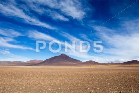 Desert and mountain over blue sky and white clouds on altiplano,bolivia Stock Photos
