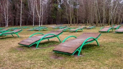 The desert on the beach. Rows of empty sun loungers in early spring Stock Photos