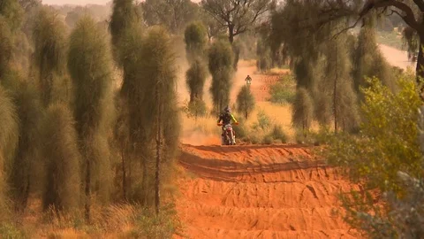 Desert Bike racer on bumpy track Stock Footage 74364914