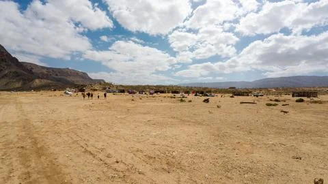 Desert camp on a wide sandy plain under cloudy sky. Socotra, Yemen. Stock Photos